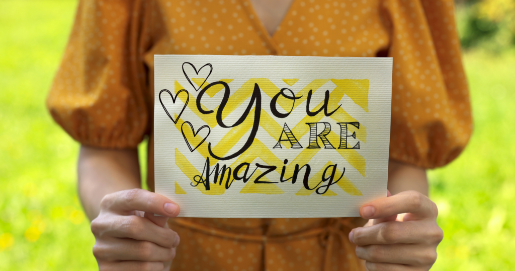 The image of a lady holding a sign that says "You Are Amazing" is designed to inspire and uplift viewers. Its purpose is to spread positivity and encouragement, reminding people of their worth and potential. This image serves as a motivational reminder to believe in oneself and recognize their unique value.