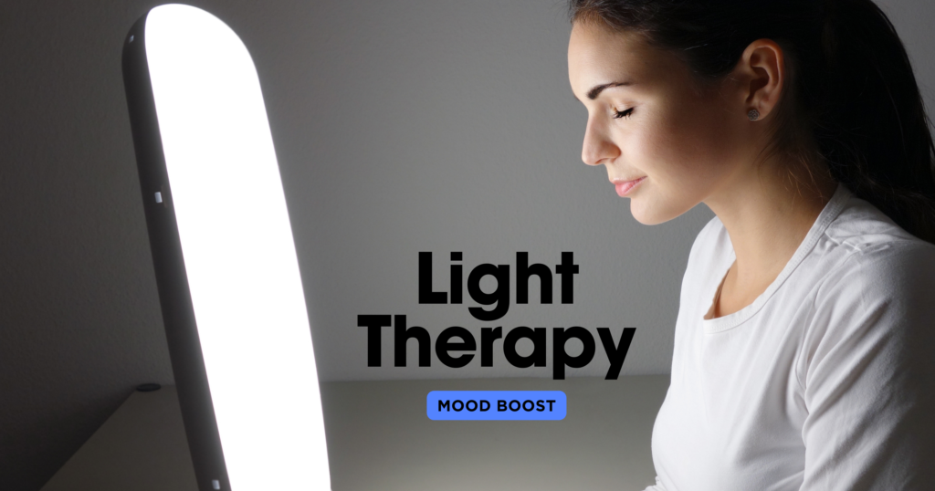 The image of a lady sitting contently with a light therapy sun lamp in a dimly lit background serves to illustrate the practical use of light therapy for mood enhancement. The serene expression on the woman's face highlights the calming and uplifting effects of the therapy, while the dimly lit background emphasizes the contrast and importance of the bright light source. This visual representation effectively communicates how light therapy can create a positive, tranquil environment, promoting mental well-being even in low-light conditions.